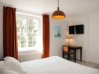 View of a comfortable and bright guest room, arranged for the rest of hikers