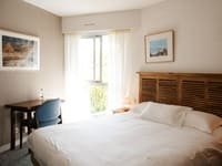 Another view of a comfortable and bright guest room, arranged for the rest of hikers